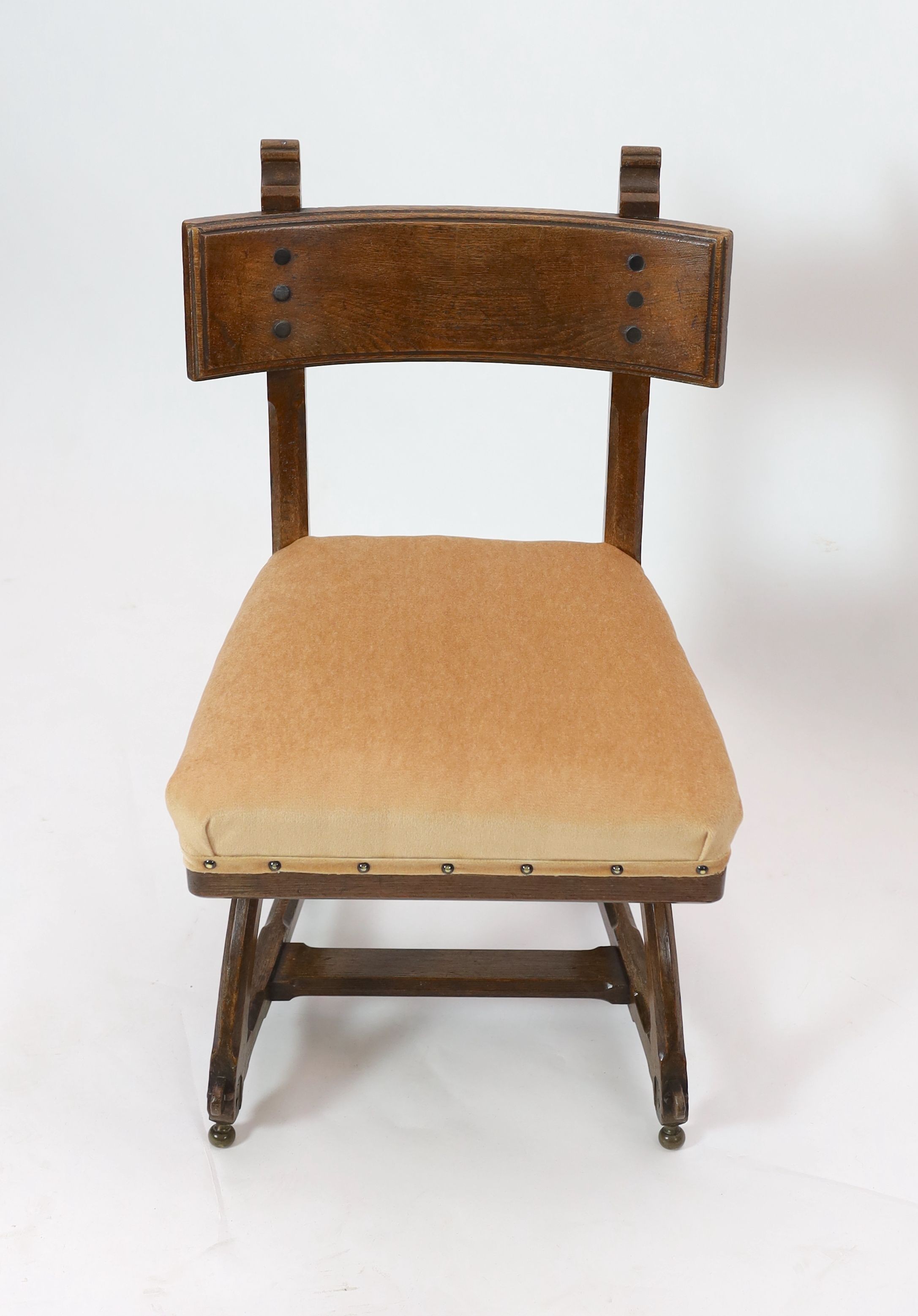A Victorian reformed gothic oak dining chair designed by Edward Welby Pugin, c.1864, W. 50cm. D. 48cm. H. 84cm.